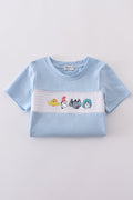 Blue Dr. Seuss smocked top with playful embroidery, perfect for kids.