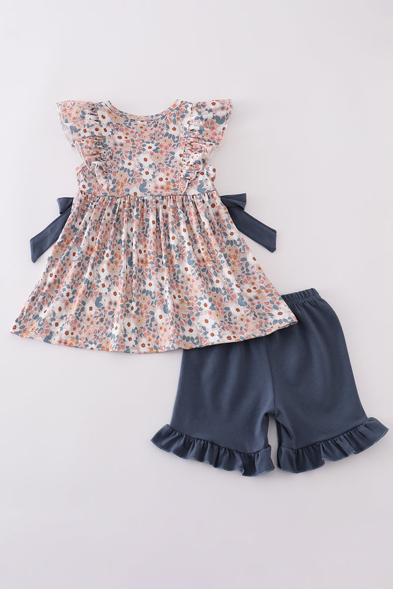 Easter-themed girls' outfit with "He is Risen" embroidery and pastel accents.