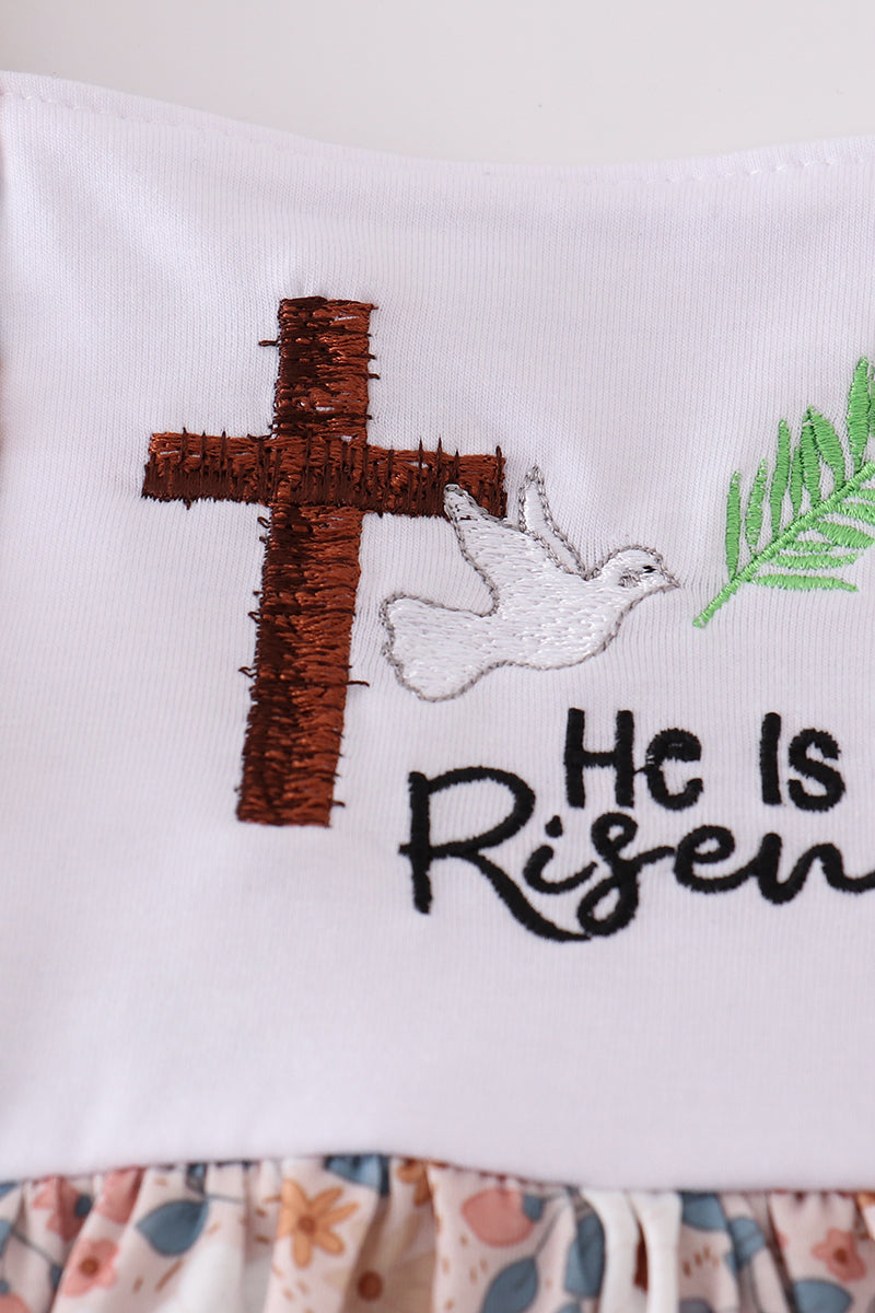 Pink Easter dress with "He is Risen" embroidery and floral accents.