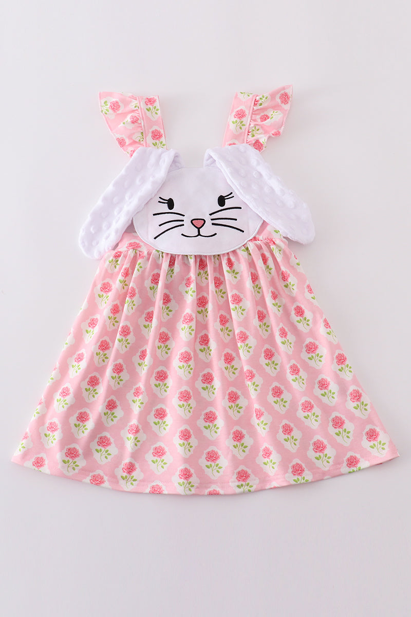 A charming pink dress with a floral bunny applique, perfect for springtime play.