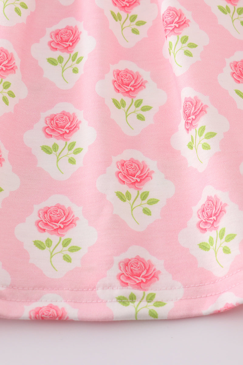 A charming pink dress with a floral bunny applique, perfect for springtime play.