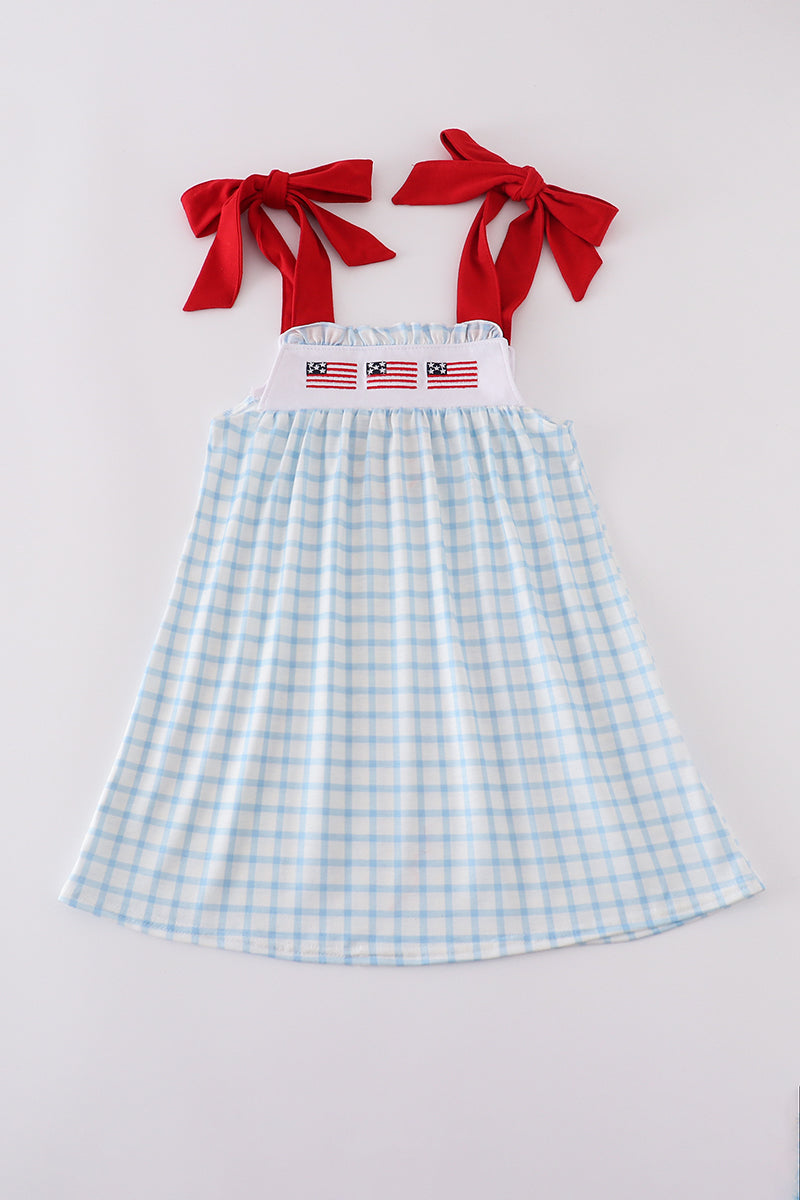 A charming blue dress with flag embroidery, perfect for playful summer days.