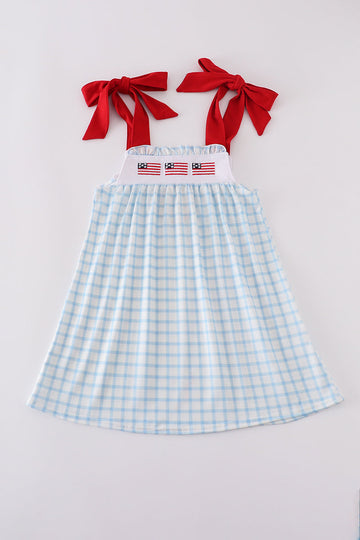 A charming blue dress with flag embroidery, perfect for playful summer days.