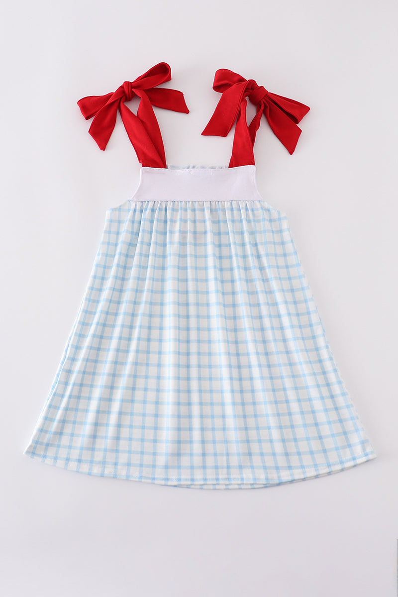 A charming blue dress with flag embroidery, perfect for playful summer days.