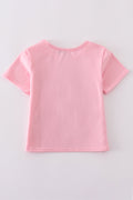 Matching pink tops with sparkly sequin bows, perfect for mom and daughter.