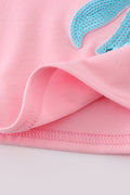 Matching pink sequin dresses with big bows, perfect for mom and daughter.