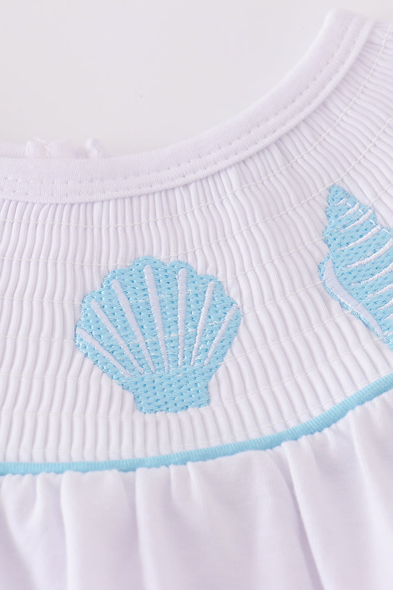 White smocked set with starfish embroidery, perfect for beach outings.