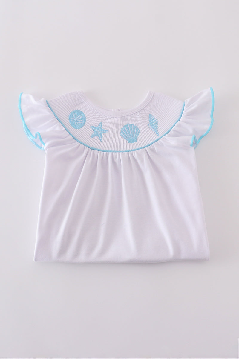 White smocked set with starfish embroidery, perfect for beach outings.