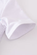 White smocked set with starfish embroidery, perfect for summer beach outings.