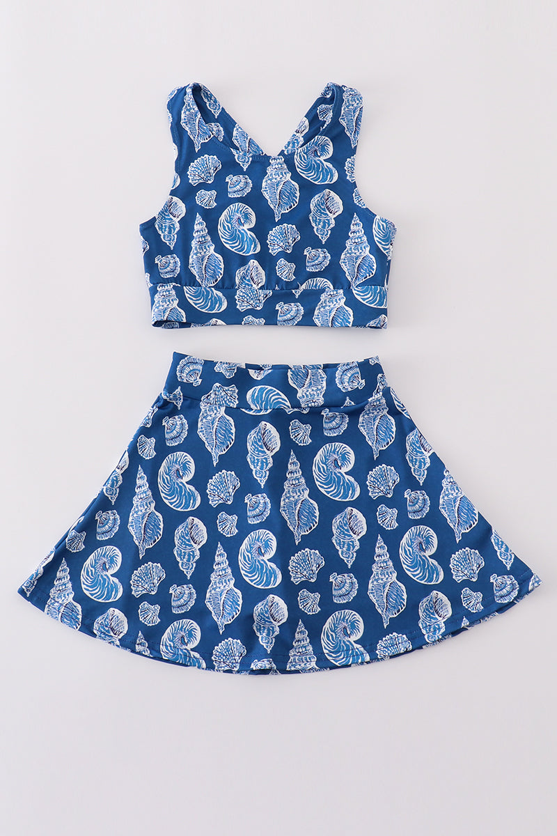 Blue conch print tennis skort set with playful ocean-themed pattern.