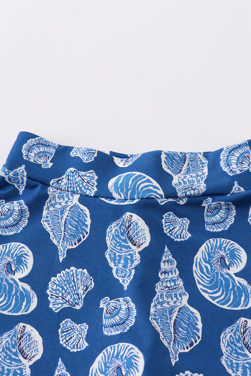 Blue conch print tennis skort set with playful ocean-themed pattern.