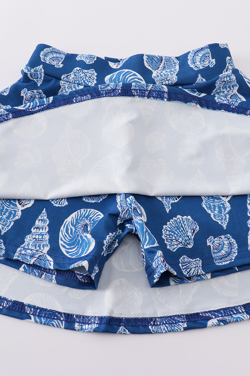 Blue conch print tennis skort set with playful ocean-themed pattern.