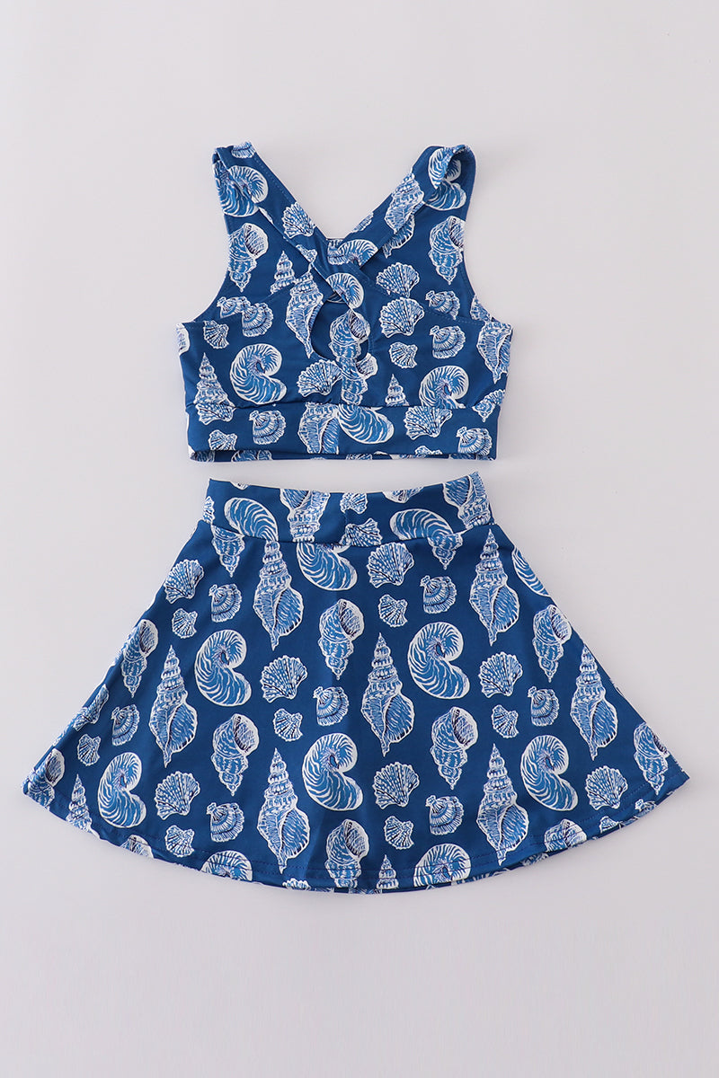 Blue conch print tennis skort set with playful ocean-themed pattern.