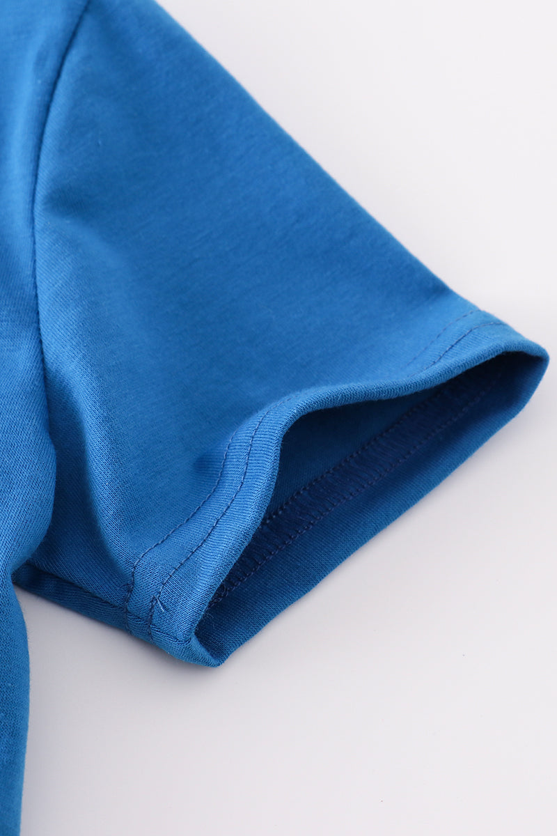 Blue top with playful airplane embroidery, perfect for kids' adventures.