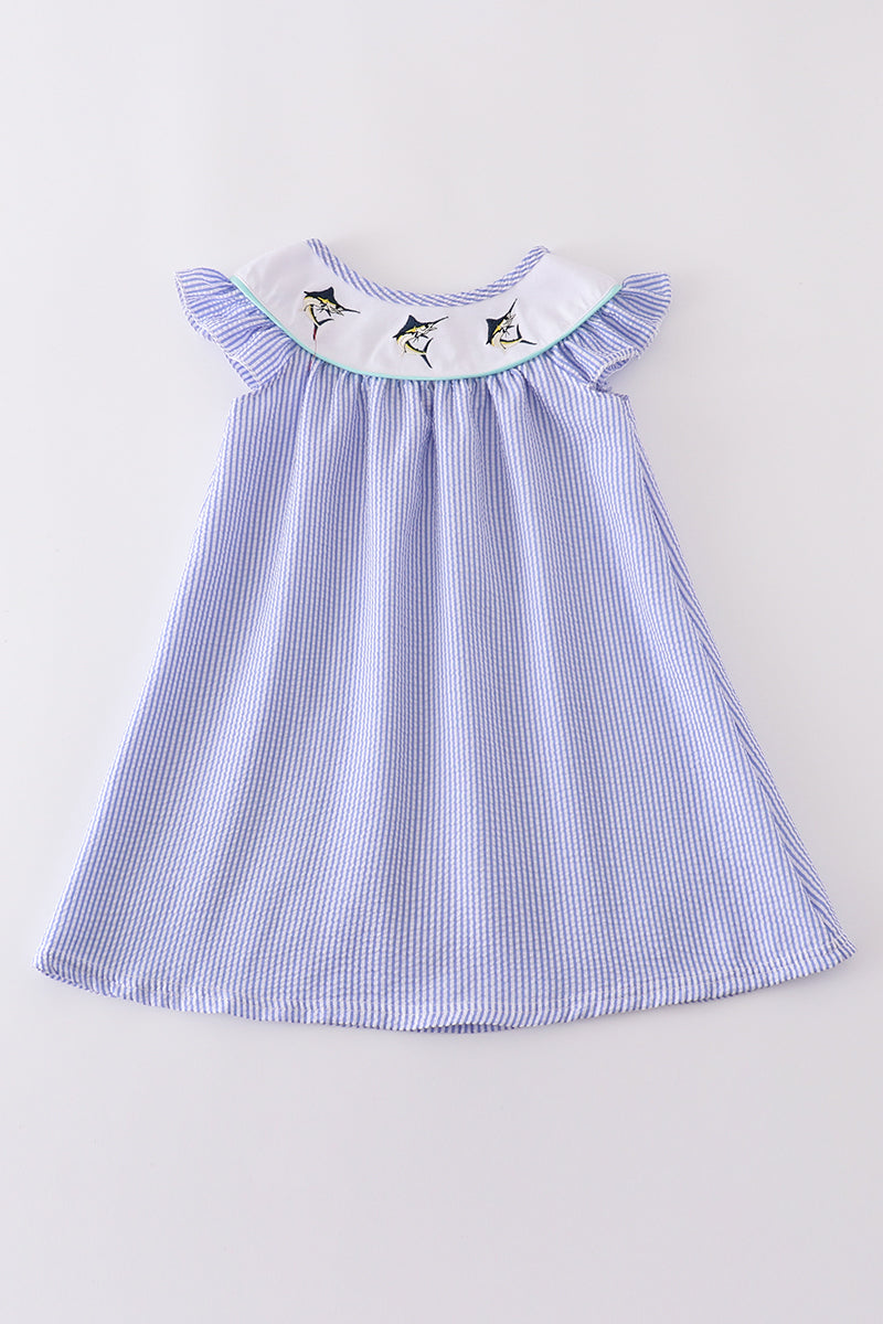 Blue stripe seersucker dress with charming swordfish embroidery, perfect for summer adventures.