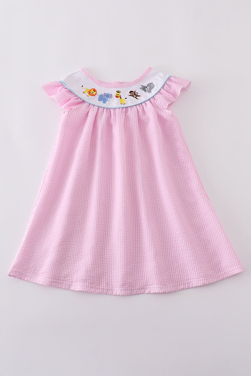 Pink seersucker dress with playful animal embroidery, perfect for spring outings.