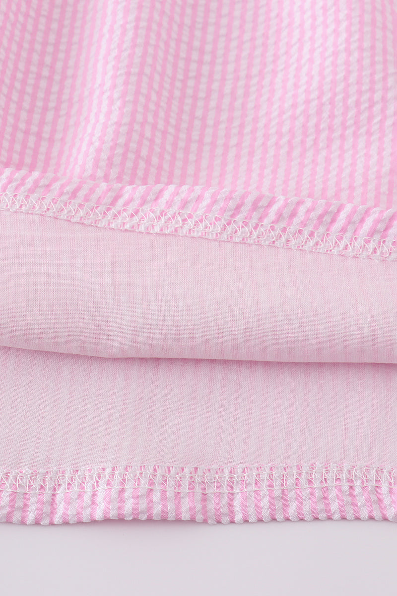 Pink seersucker dress with playful animal embroidery, perfect for spring outings.