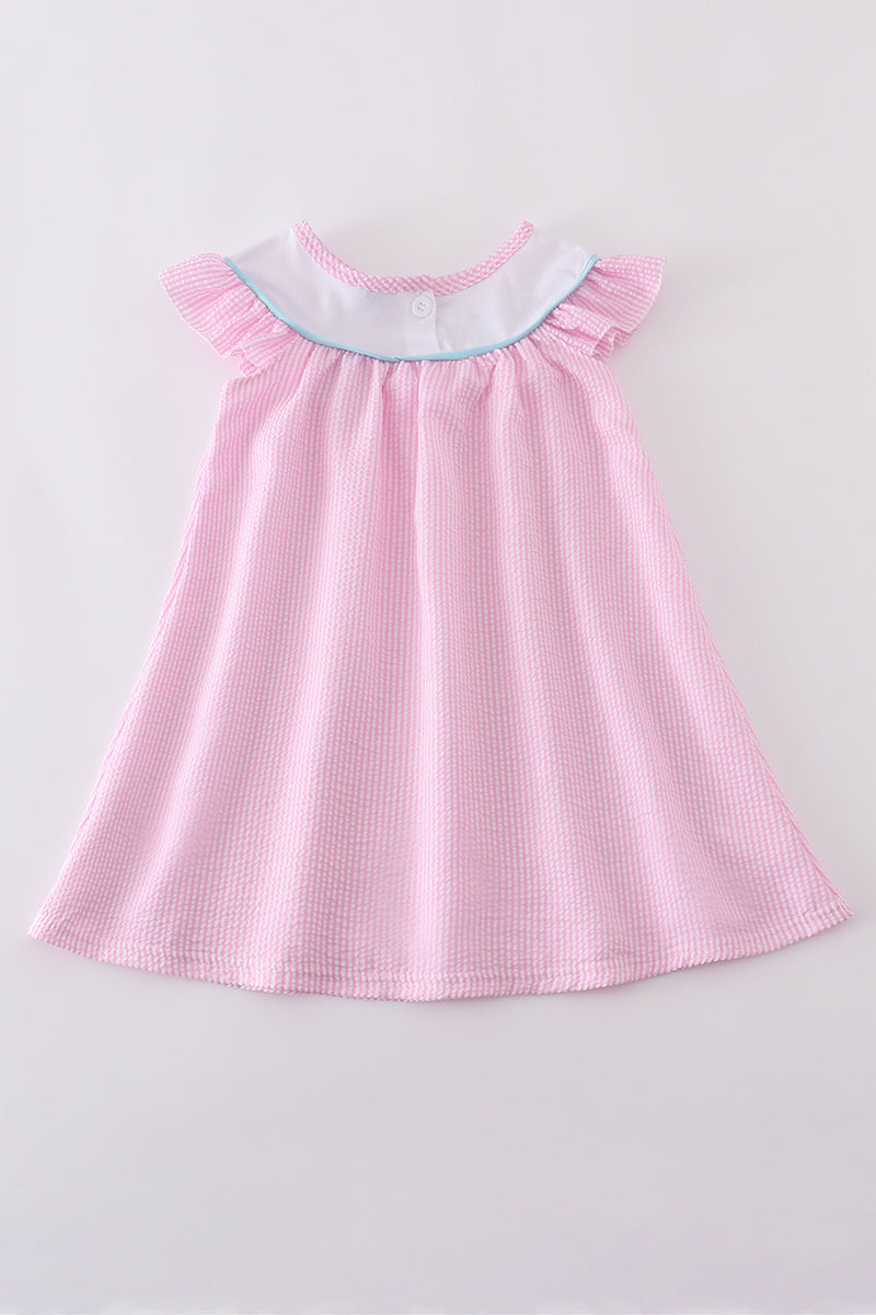 Pink seersucker dress with playful animal embroidery, perfect for spring outings.
