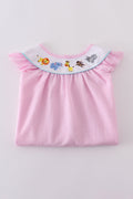 Pink seersucker dress with playful animal embroidery, perfect for spring outings.