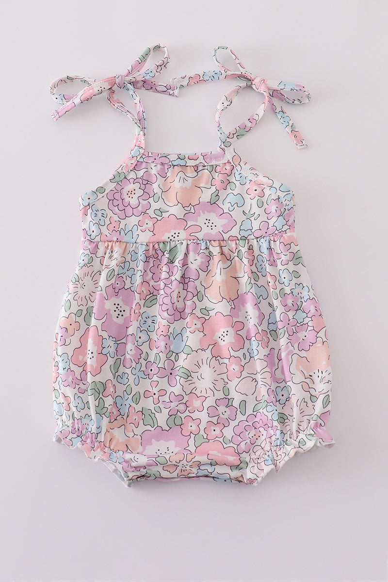 Pink blush bubble romper with a garden bloom print, perfect for spring outings.