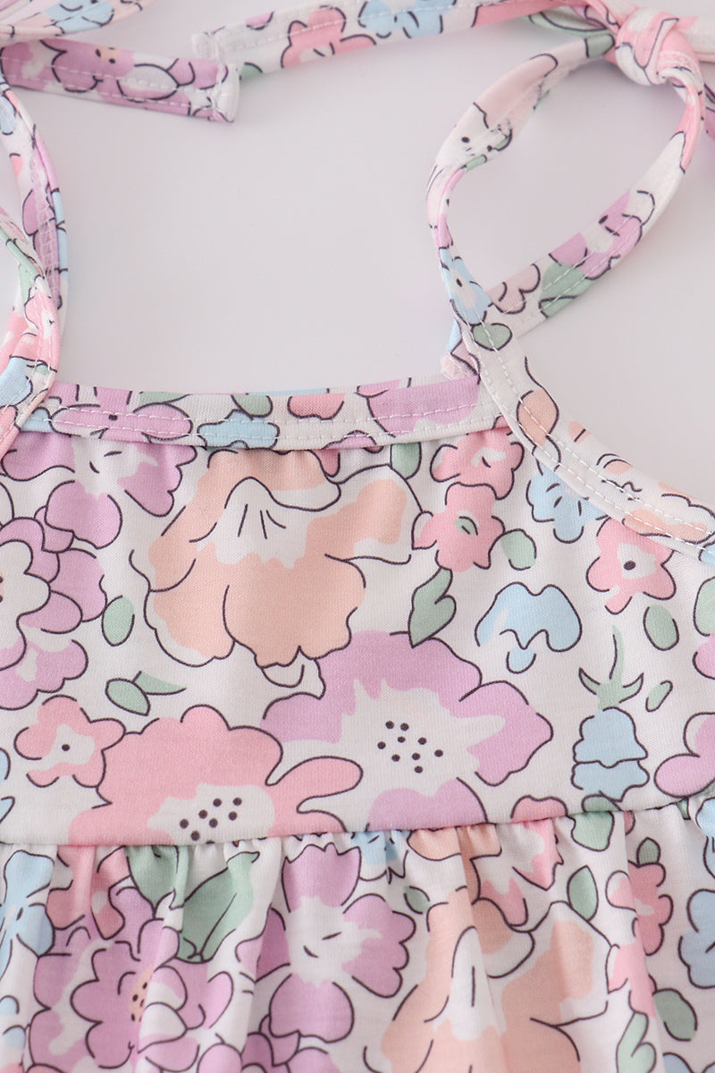 Pink blush bubble romper with a garden bloom print, perfect for spring outings.