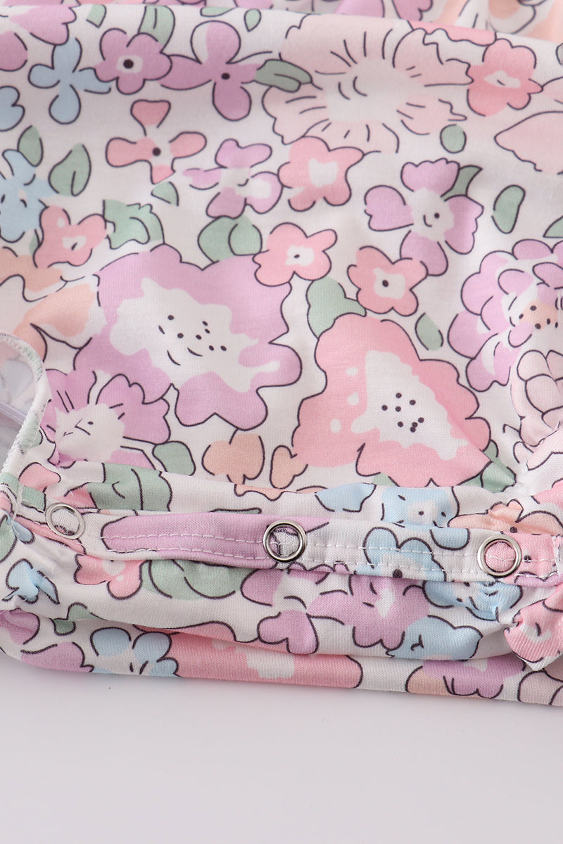 Pink blush bubble romper with a garden bloom print, perfect for spring outings.