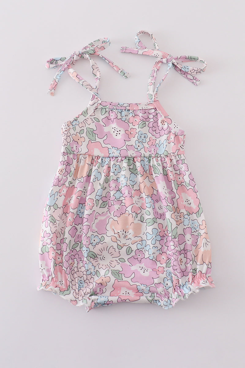 Pink blush bubble romper with a garden bloom print, perfect for spring outings.