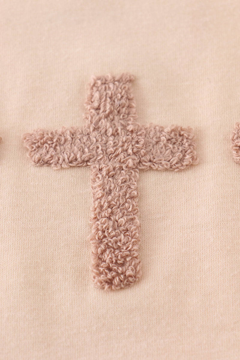 Cream top with delicate cross-stitch knots, perfect for everyday play.