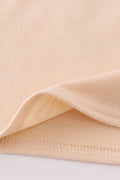 Cream top with delicate cross-stitch knots, perfect for everyday play.