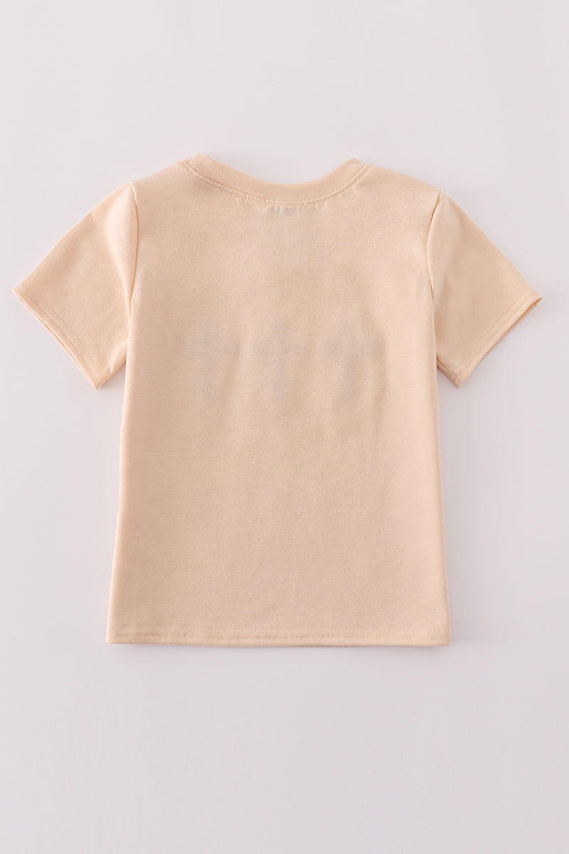 Cream top with delicate cross-stitch knots, perfect for everyday play.