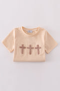 Cream top with delicate cross-stitch knots, perfect for everyday play.
