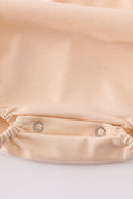 Cream bubble romper with delicate cross French knot embroidery, perfect for special occasions.