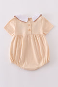Cream bubble romper with delicate cross French knot embroidery, perfect for special occasions.