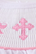A sweet pink smocked set with delicate cross embroidery, perfect for playdates.