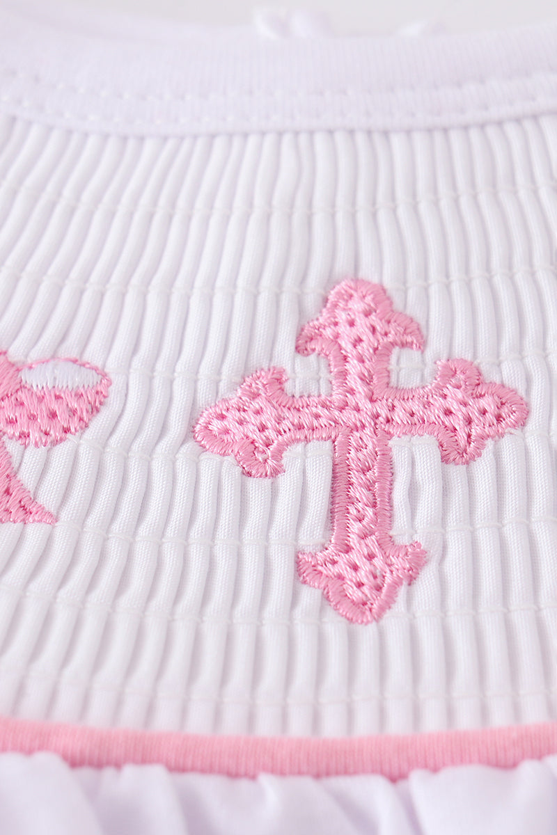 A sweet pink smocked set with delicate cross embroidery, perfect for playdates.