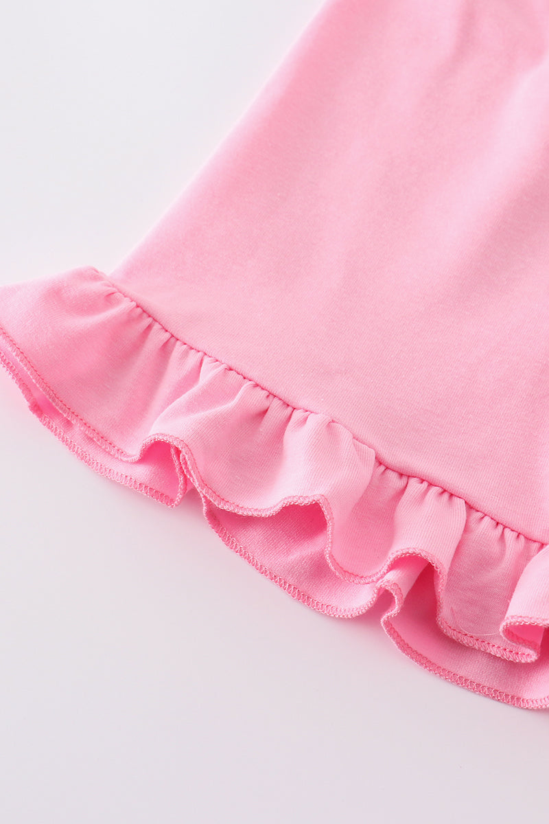 A sweet pink smocked set with delicate cross embroidery, perfect for playdates.