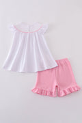 A sweet pink smocked set with delicate cross embroidery, perfect for playdates.