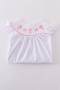 A sweet pink smocked set with delicate cross embroidery, perfect for playdates.