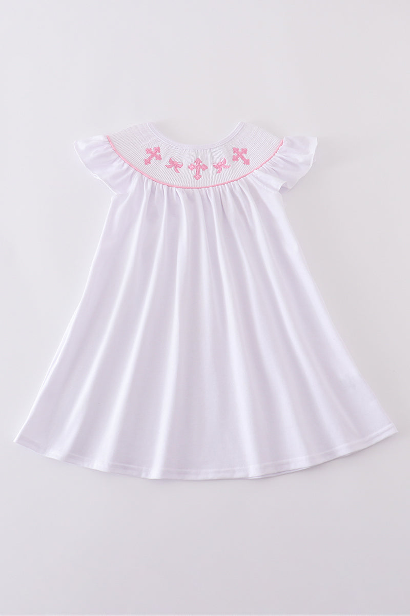 A charming pink dress with cross embroidery and smocked detailing, perfect for playdates.