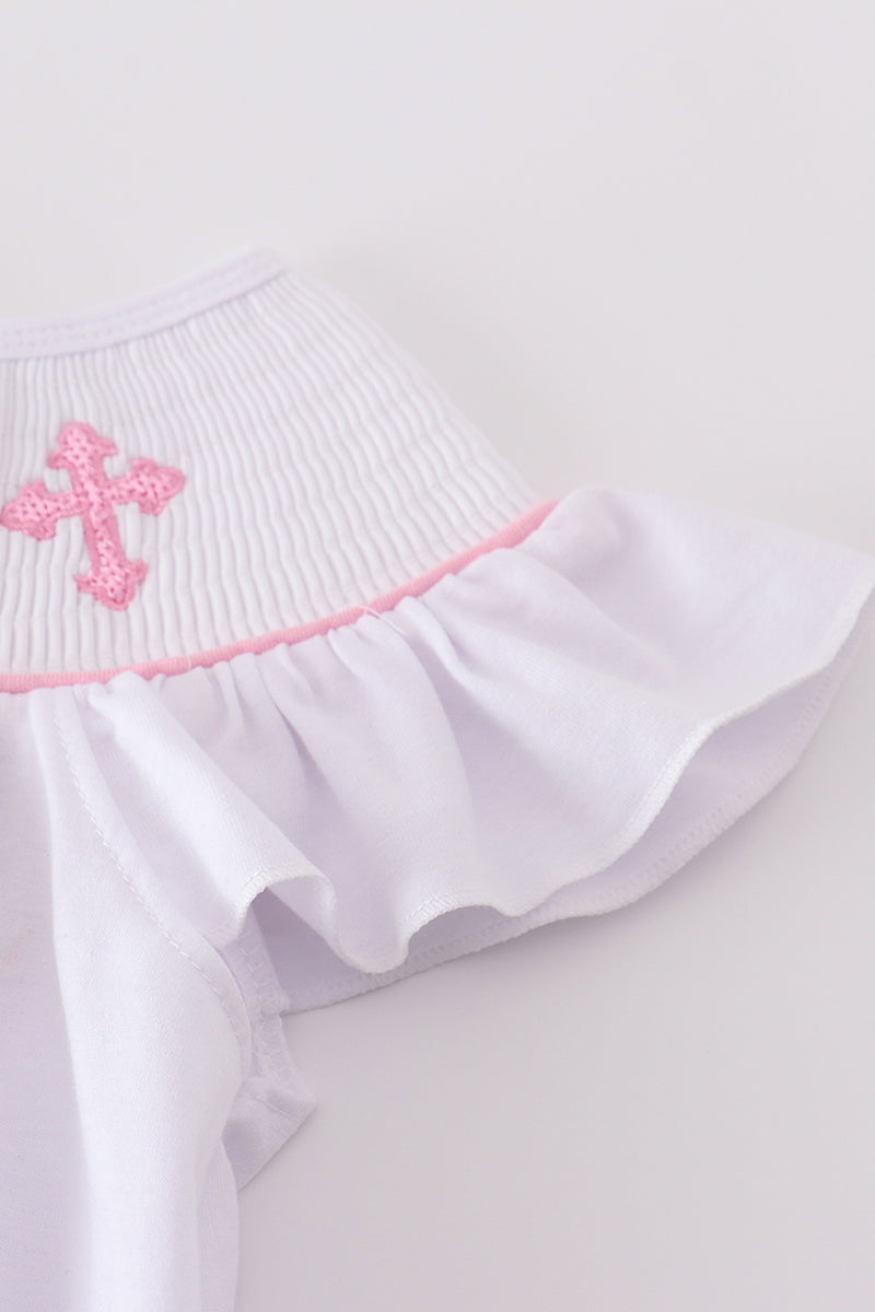 A charming pink dress with cross embroidery and smocked detailing, perfect for playdates.