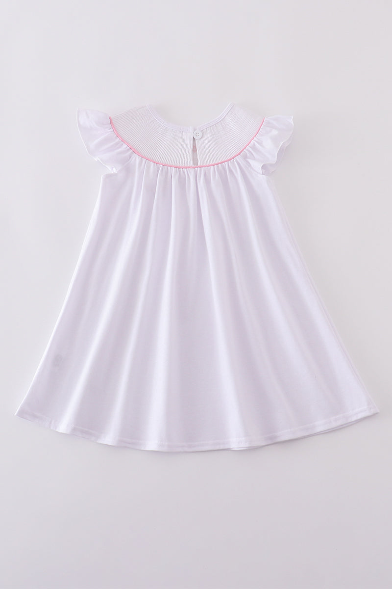 A charming pink dress with cross embroidery and smocked detailing, perfect for playdates.