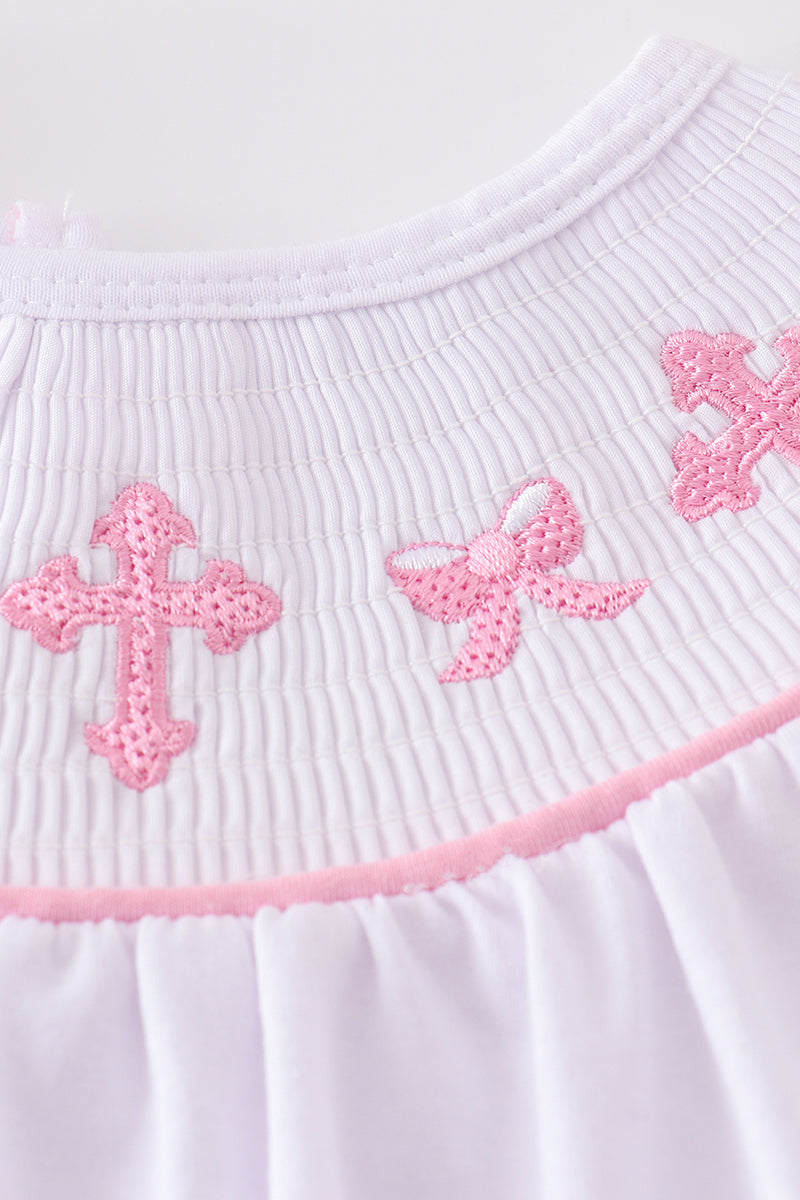 Pink smocked bloomer set with cross embroidery, perfect for special occasions.