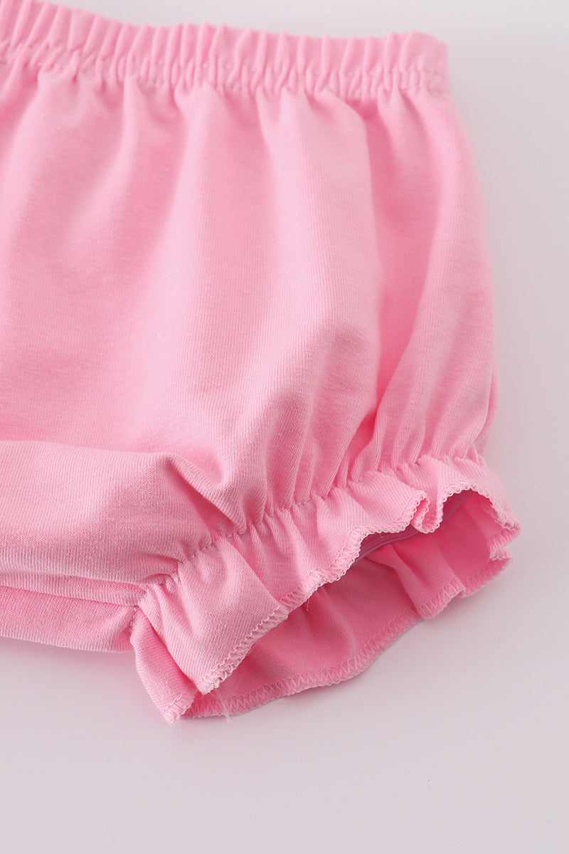 Pink smocked bloomer set with cross embroidery, perfect for special occasions.
