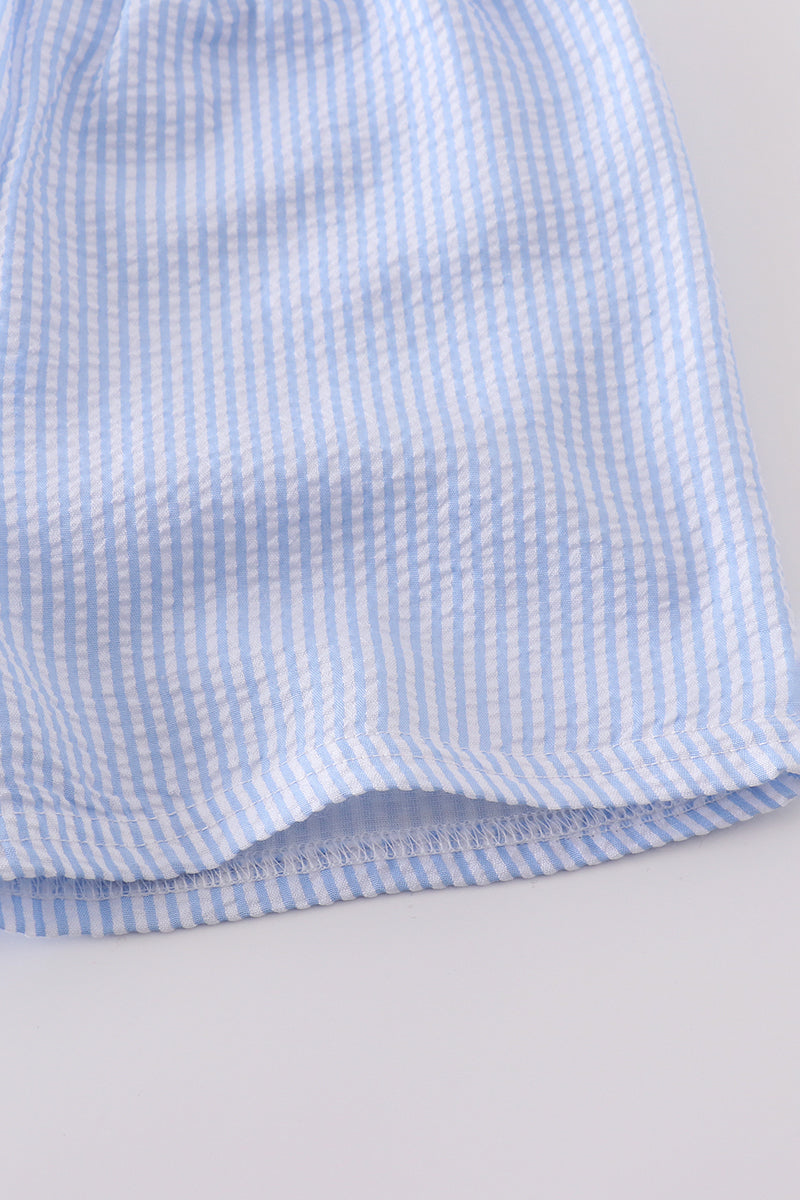 A charming blue smocked set with cross embroidery, perfect for special occasions.
