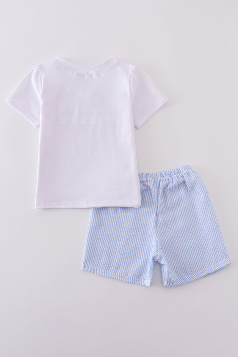 A charming blue smocked set with cross embroidery, perfect for special occasions.