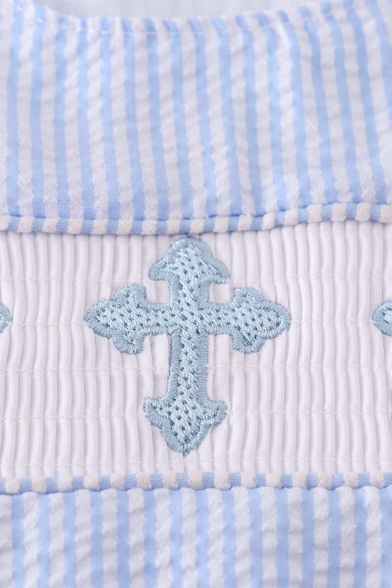 A charming blue smocked set with delicate cross embroidery, perfect for special occasions.