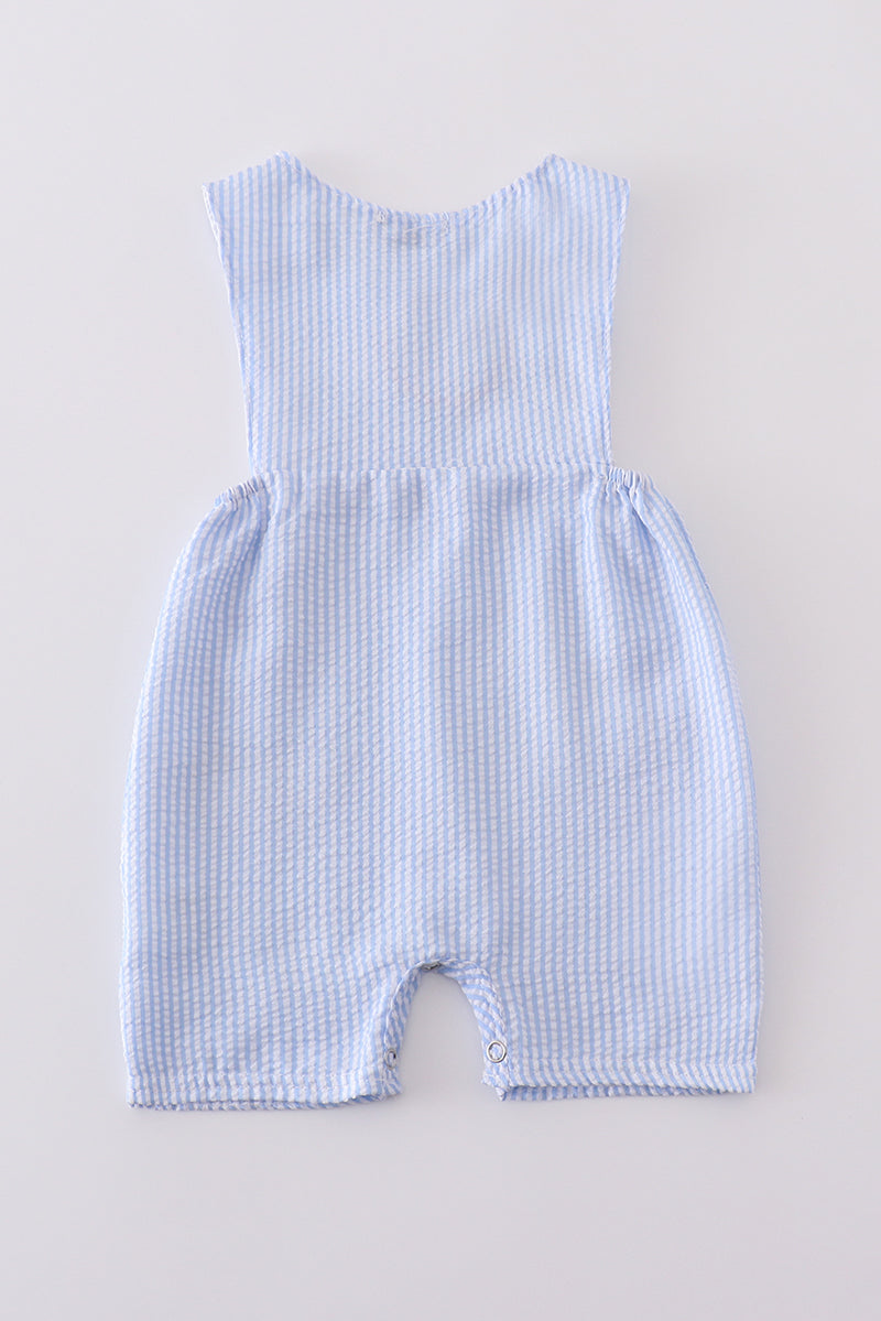 A charming blue smocked set with delicate cross embroidery, perfect for special occasions.