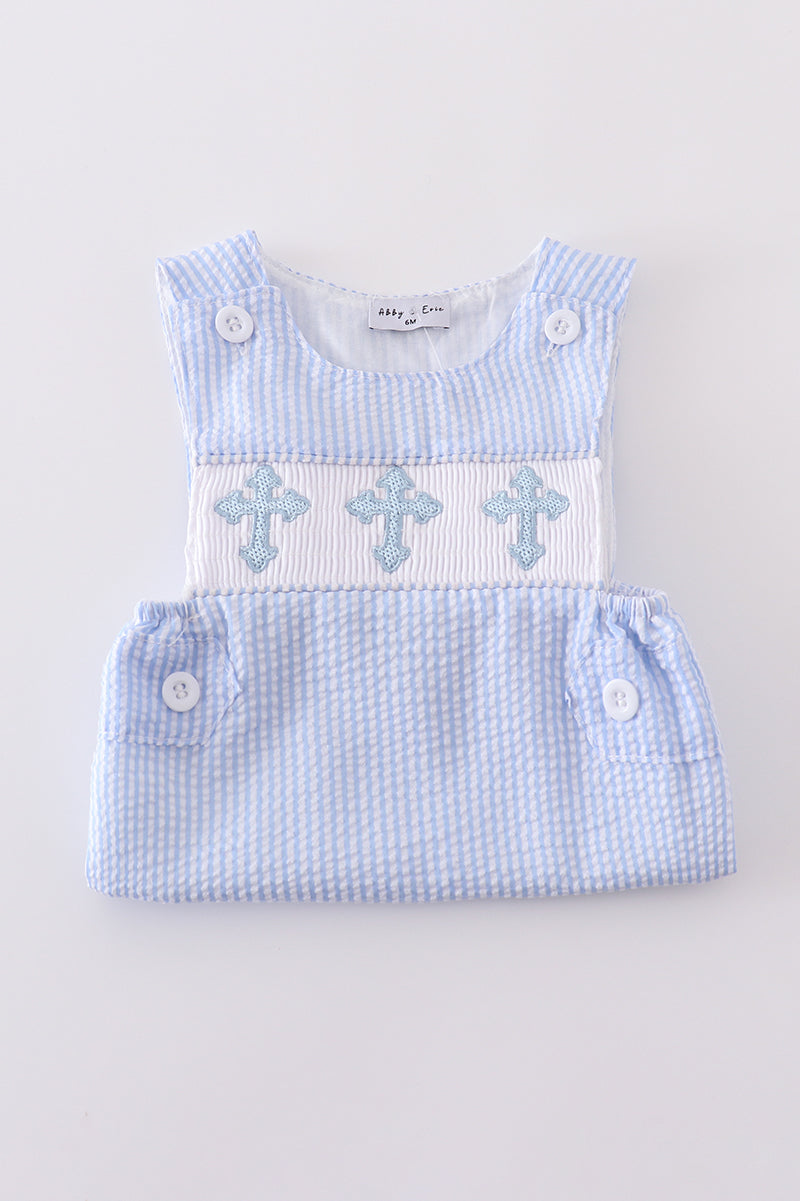 A charming blue smocked set with delicate cross embroidery, perfect for special occasions.