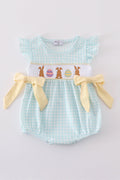 A blue smocked bubble with adorable bunny embroidery, perfect for spring outings.