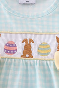 A blue smocked bubble with adorable bunny embroidery, perfect for spring outings.